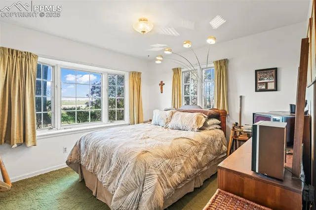 a bedroom with a bed and glass window