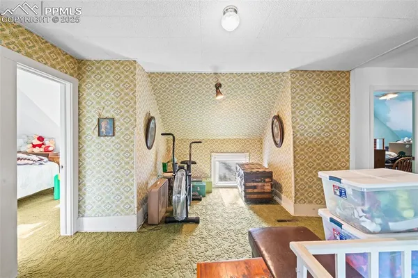 a living room with furniture and a painting on the wall