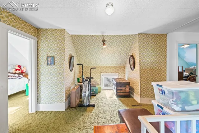 a living room with furniture and a painting on the wall