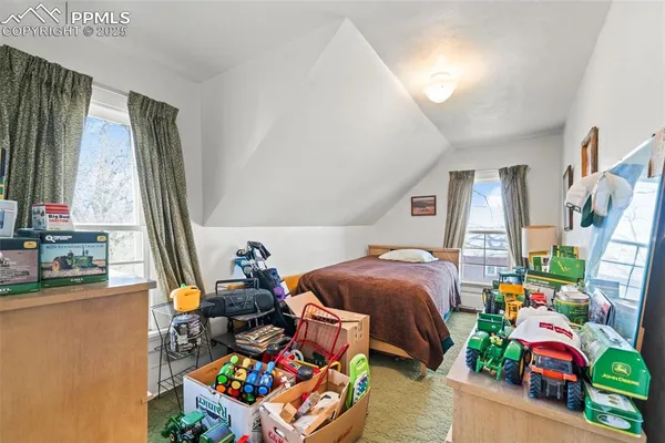 a bedroom with bed and a window