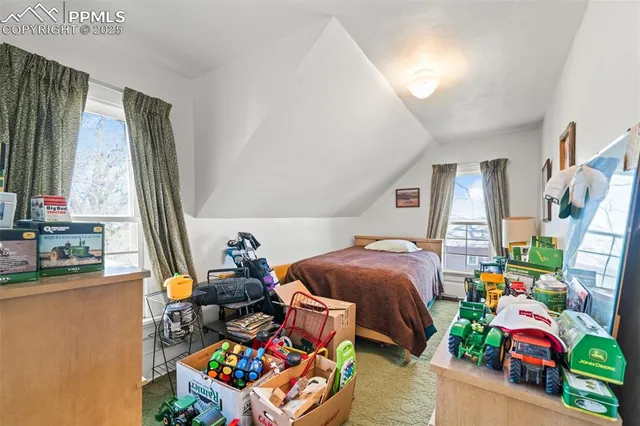 a bedroom with bed and a window