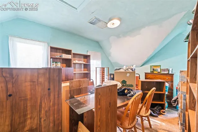 a view of a dining room with furniture and a window