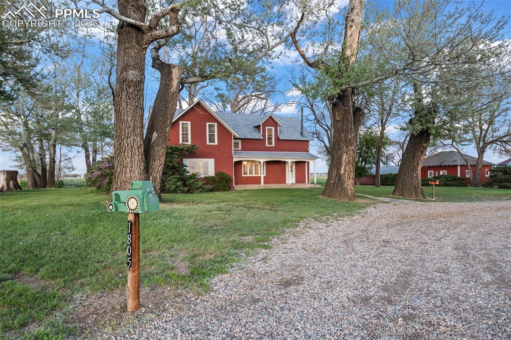 1805 West County Road 8 Berthoud, CO 80513 - Photo 47 of 48 a front view of a house with a yard and tree
