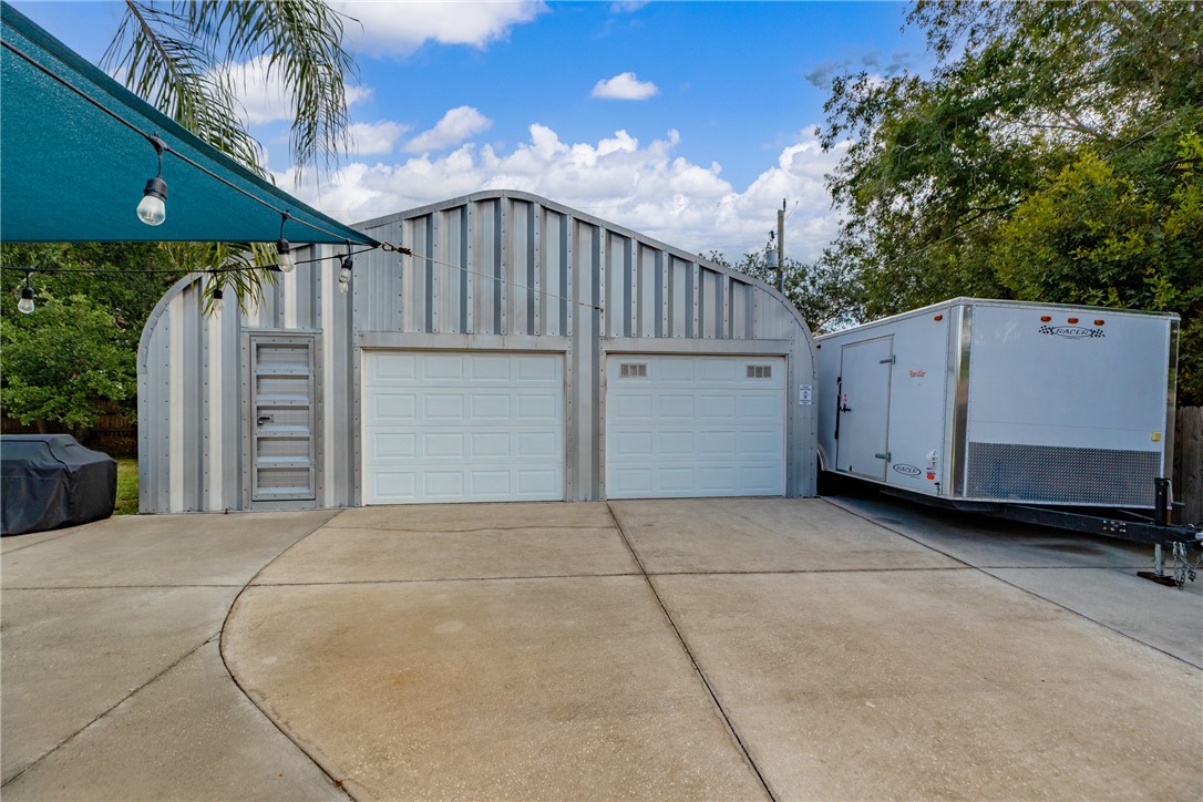7666 134th Street Sebastian, FL 32958 - Photo 29 of 35 a view of a house with a backyard and garage