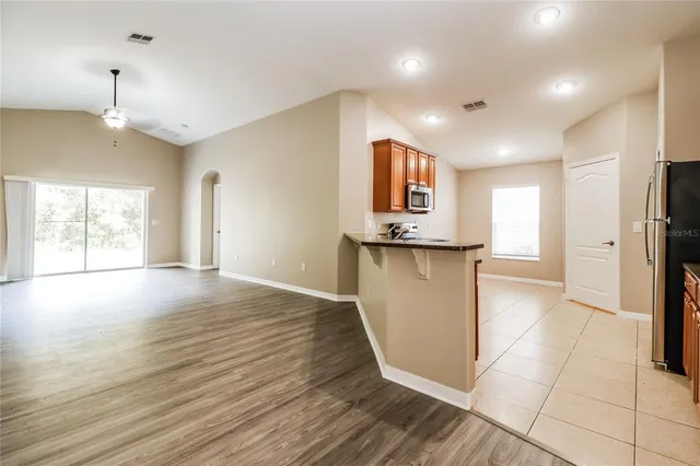 a view of a kitchen center island and wooden floor