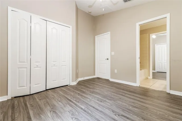 a view of an empty room with wooden floor