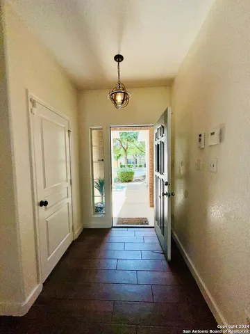 a view of a hallway view with wooden floor and staircase
