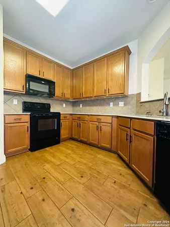 a kitchen with stainless steel appliances granite countertop a stove sink and cabinets