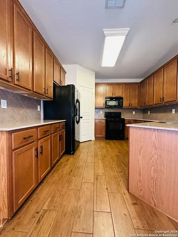 a kitchen with stainless steel appliances granite countertop a refrigerator stove and sink