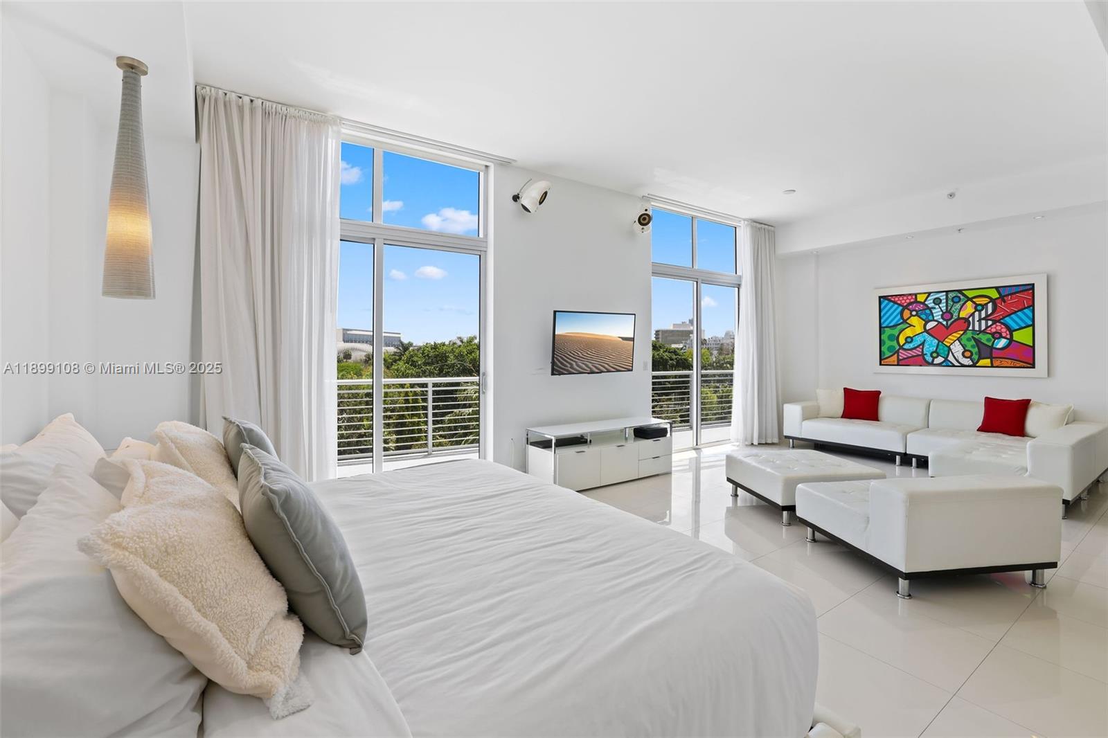 2001 Meridian Avenue, Unit 506 Miami Beach, FL 33139 - Photo 11 of 40 a bedroom with a bed and a large window