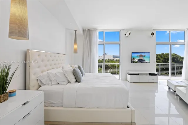 a large white bed in a white room