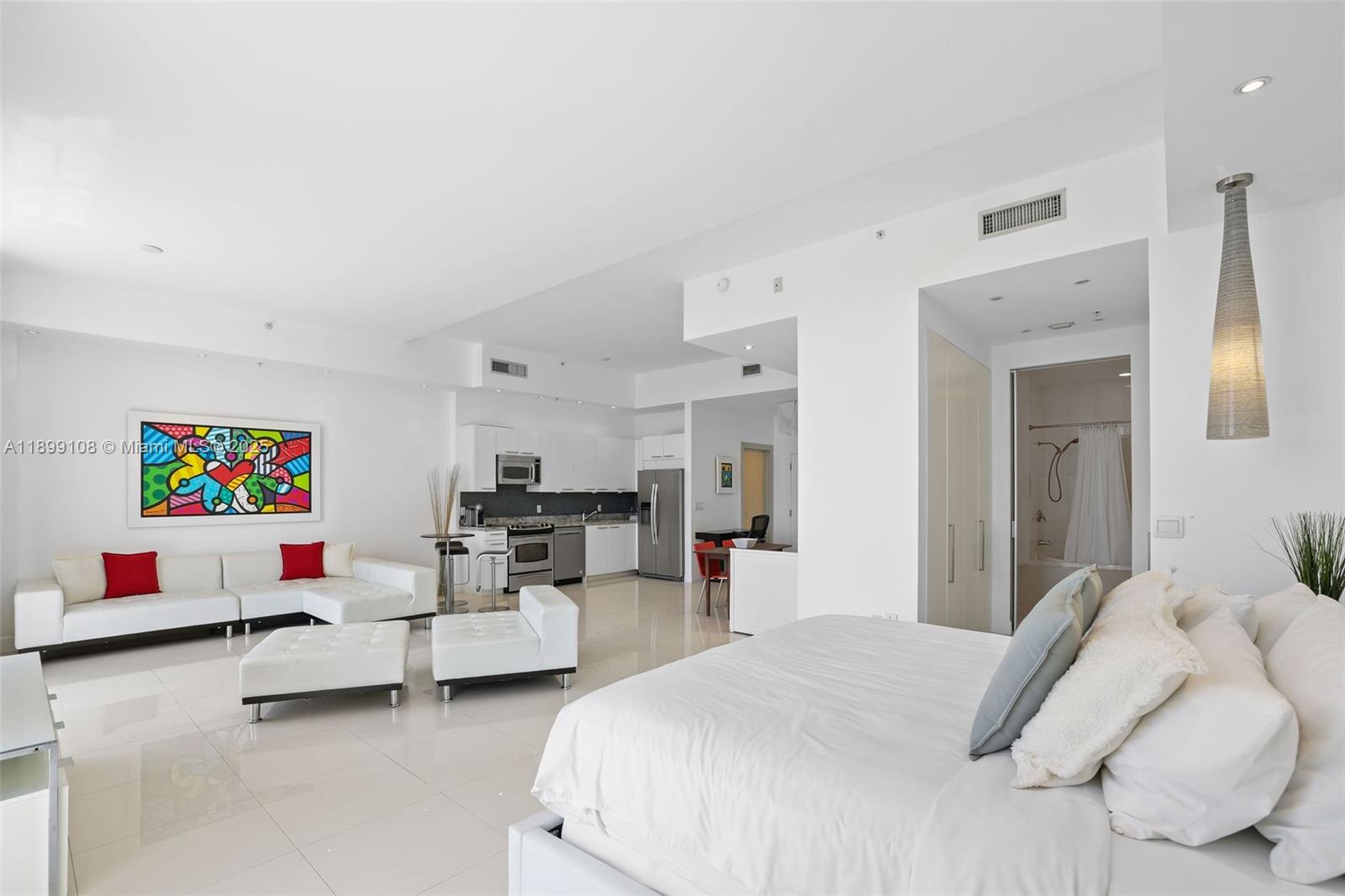 2001 Meridian Avenue, Unit 506 Miami Beach, FL 33139 - Photo 15 of 40 a bedroom with furniture and a flat screen tv