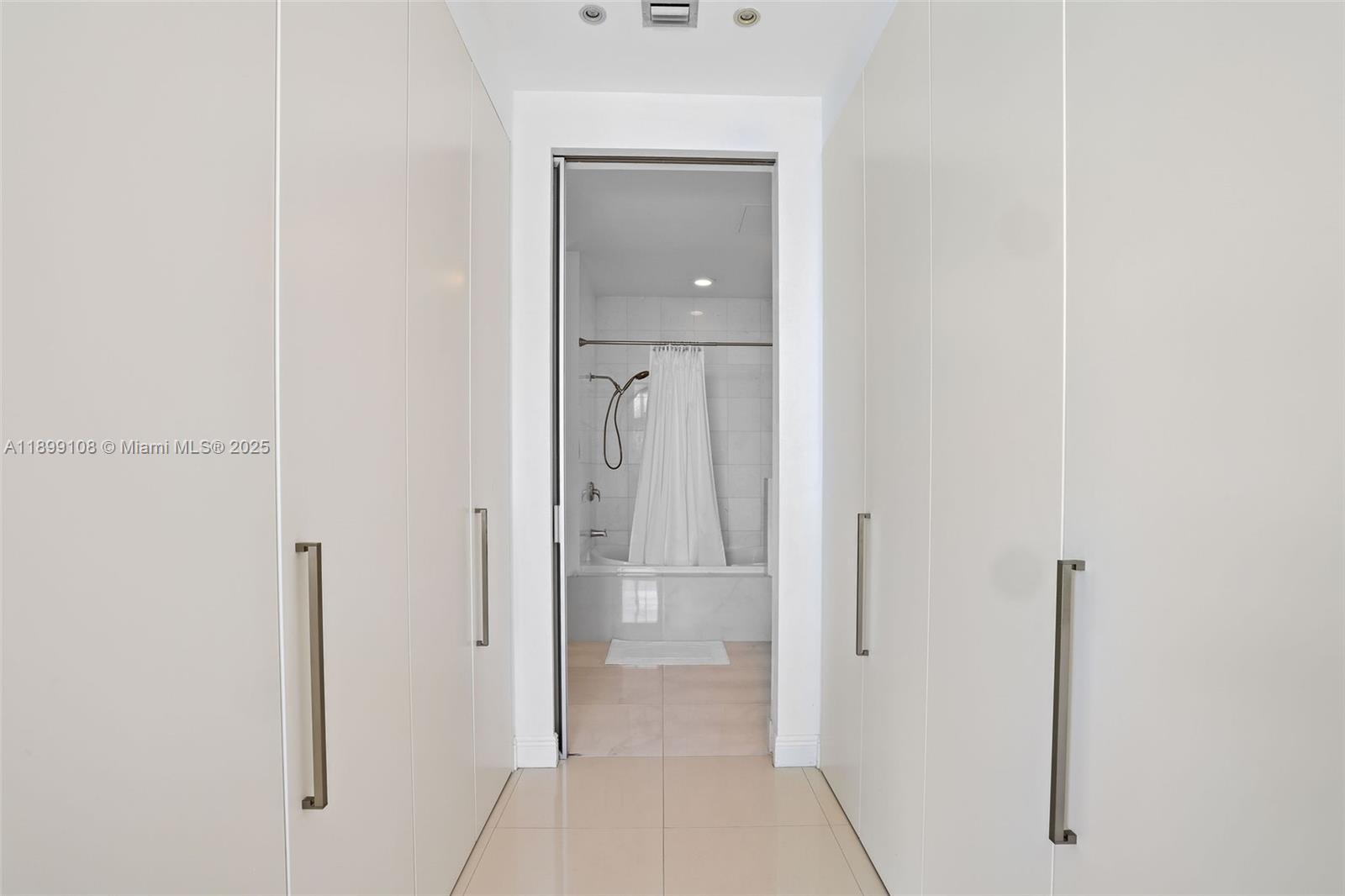 2001 Meridian Avenue, Unit 506 Miami Beach, FL 33139 - Photo 17 of 40 a view of a hallway with closet and mirror