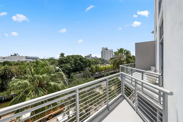 a view of balcony with lots of trees