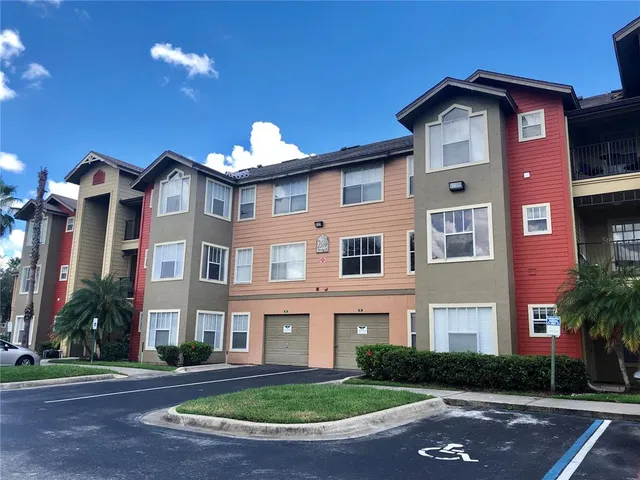 a front view of a house with a garden and plants