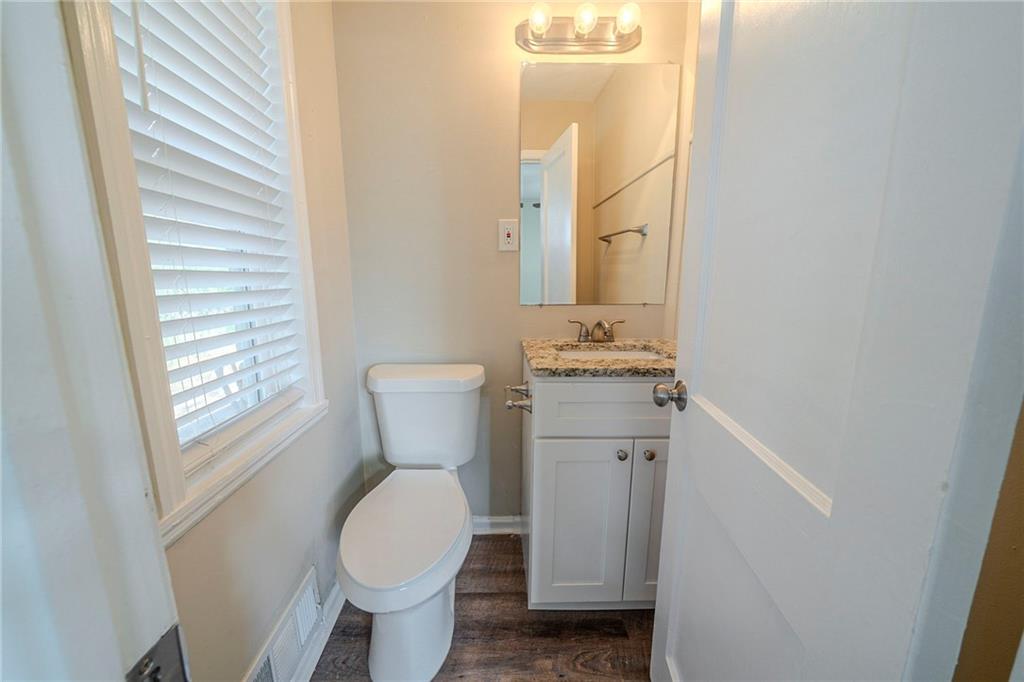 1433 Dennis Drive Decatur, GA 30032 - Photo 11 of 28 a bathroom with a toilet sink and mirror