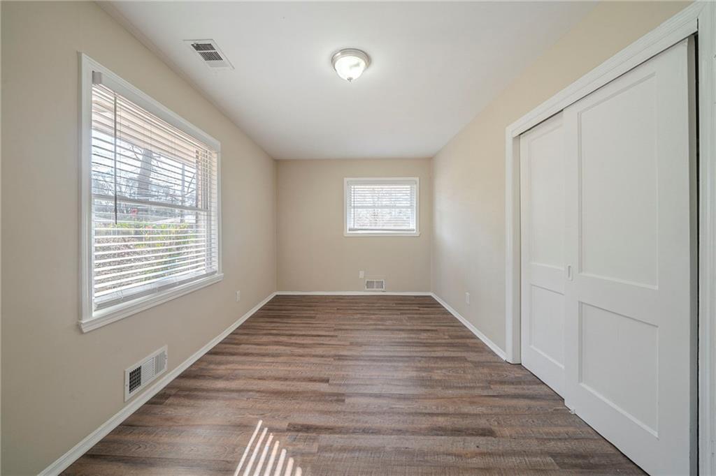 1433 Dennis Drive Decatur, GA 30032 - Photo 14 of 28 a view of an empty room with wooden floor and a window