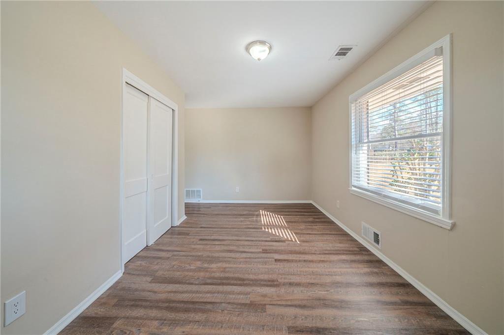 1433 Dennis Drive Decatur, GA 30032 - Photo 15 of 28 a view of an empty room with wooden floor and a window
