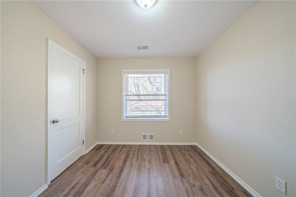 1433 Dennis Drive Decatur, GA 30032 - Photo 16 of 28 an empty room with a window and wooden floor