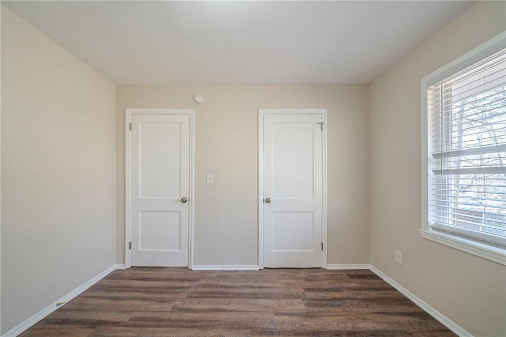 1433 Dennis Drive Decatur, GA 30032 - Photo 17 of 28 a view of an empty room with wooden floor and a window