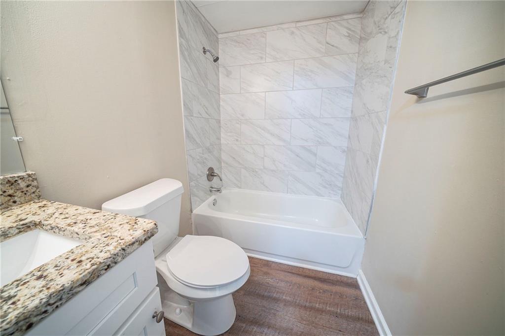 1433 Dennis Drive Decatur, GA 30032 - Photo 22 of 28 a bathroom with a granite countertop sink toilet and shower