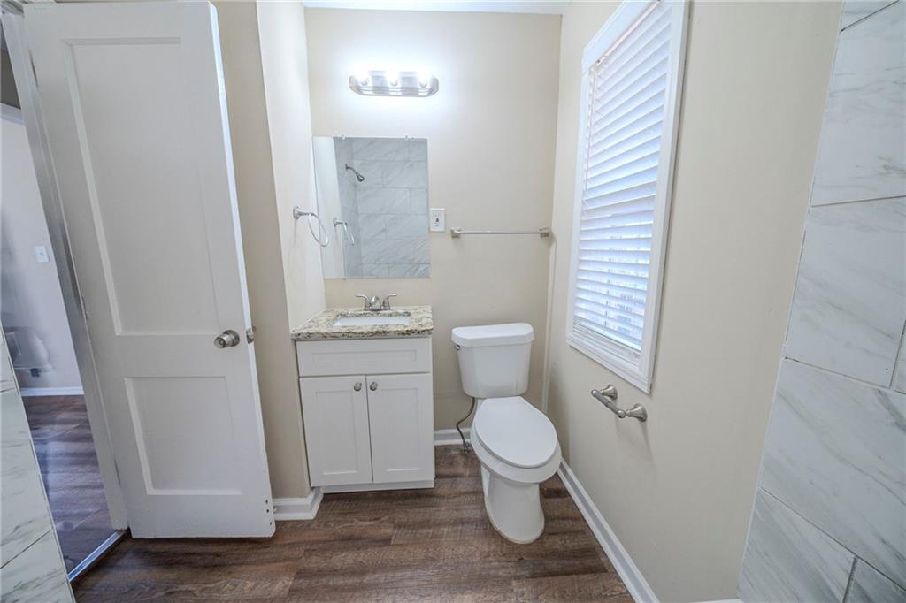 1433 Dennis Drive Decatur, GA 30032 - Photo 23 of 28 a white toilet sitting next to a bathroom sink