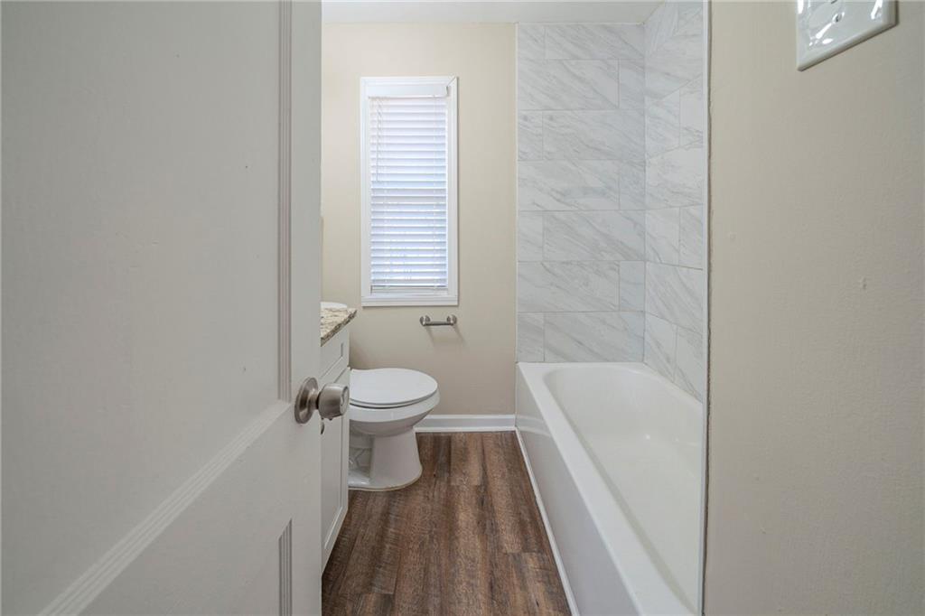 1433 Dennis Drive Decatur, GA 30032 - Photo 24 of 28 a bathroom with a toilet and a bathtub