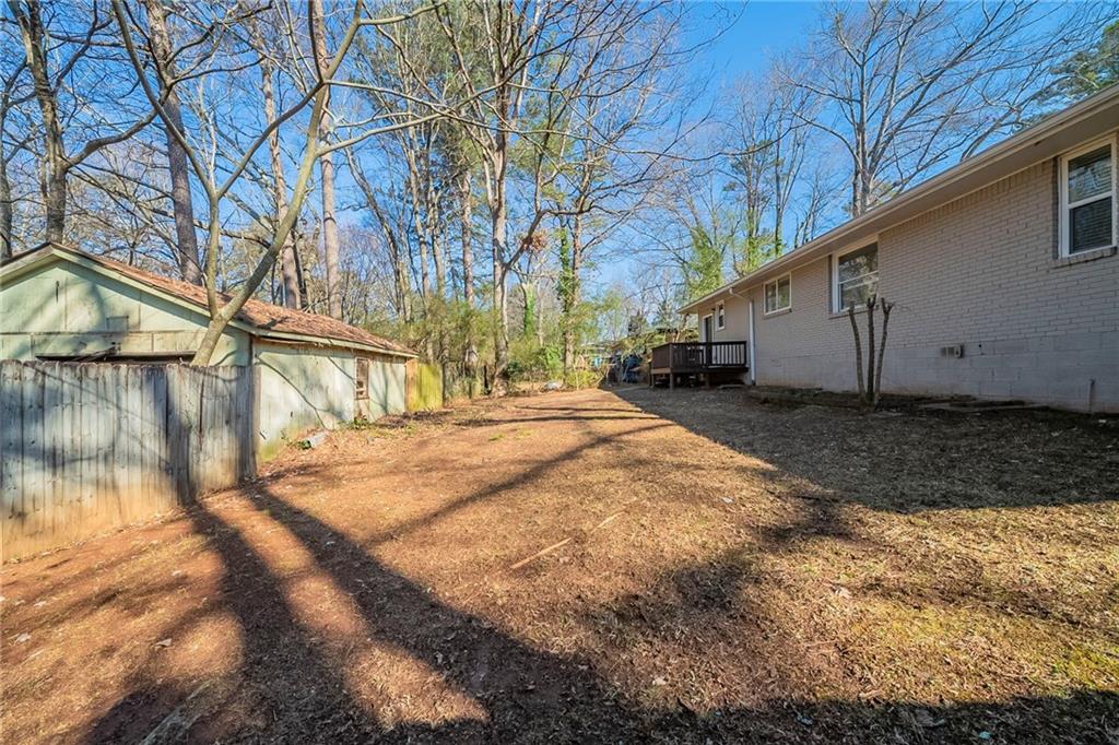 1433 Dennis Drive Decatur, GA 30032 - Photo 26 of 28 a backyard of a house with a yard and garage