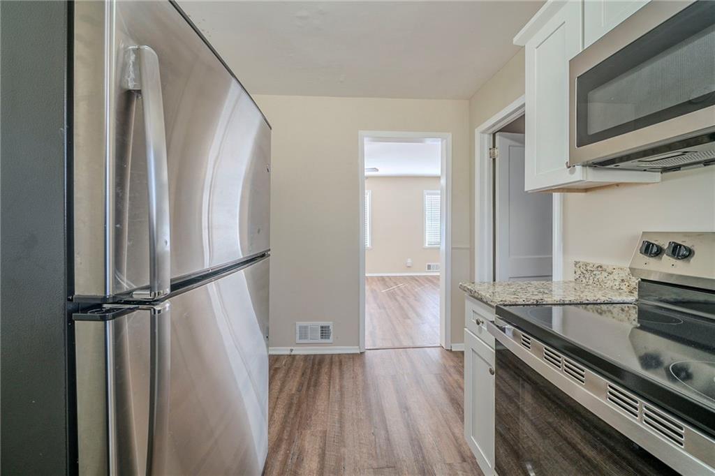 1433 Dennis Drive Decatur, GA 30032 - Photo 3 of 28 a kitchen with a refrigerator and a stove top oven
