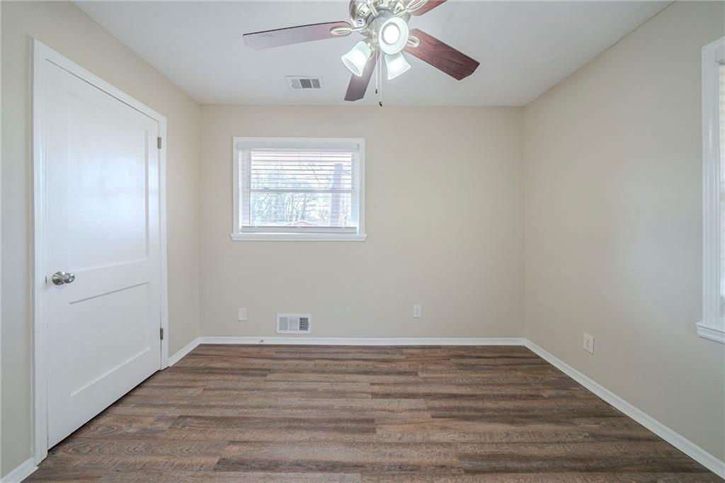 1433 Dennis Drive Decatur, GA 30032 - Photo 10 of 28 a view of an empty room with wooden floor and a window