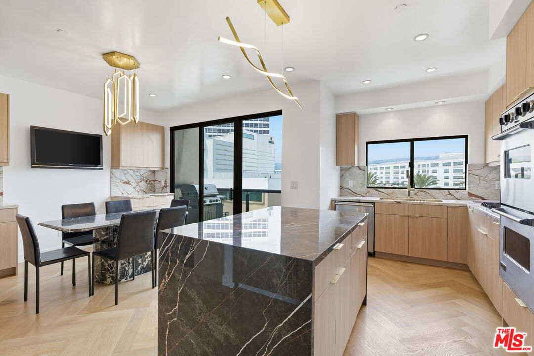 a large kitchen with a table and chairs