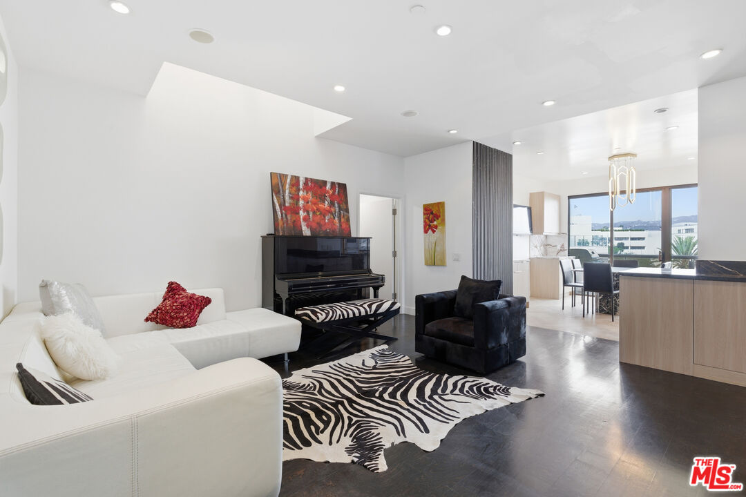 121 South Canon Drive, Unit PH 401 Beverly Hills, CA 90212 - Photo 13 of 31 a living room with furniture and a flat screen tv