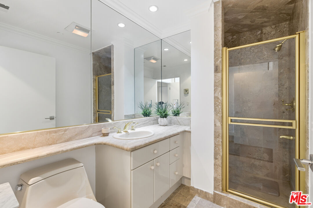 121 South Canon Drive, Unit PH 401 Beverly Hills, CA 90212 - Photo 17 of 31 a bathroom with a sink and a mirror