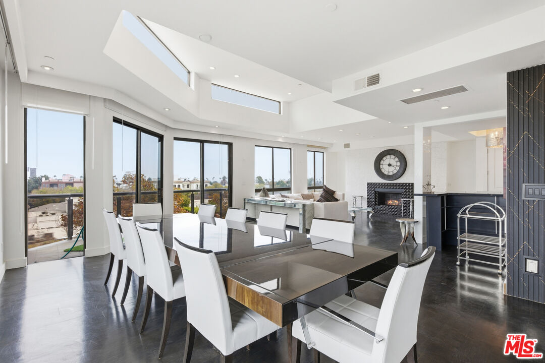 121 South Canon Drive, Unit PH 401 Beverly Hills, CA 90212 - Photo 2 of 31 a view of a dining room with furniture window and outside view