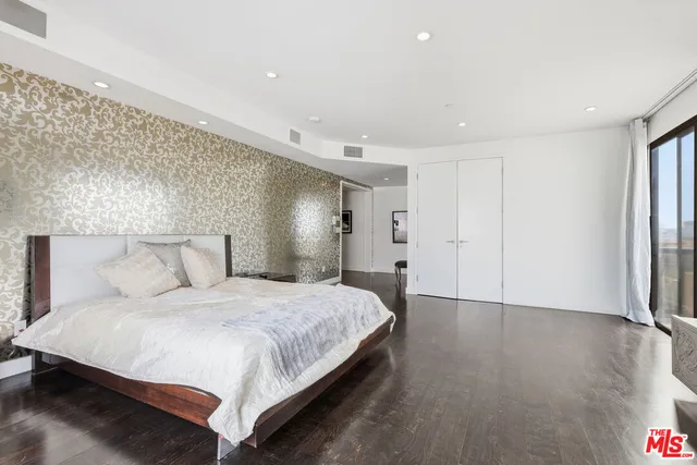 a bedroom with a bed and a night stand