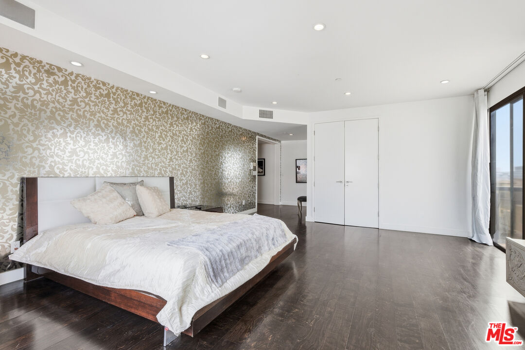 121 South Canon Drive, Unit PH 401 Beverly Hills, CA 90212 - Photo 21 of 31 a bedroom with a bed and a night stand