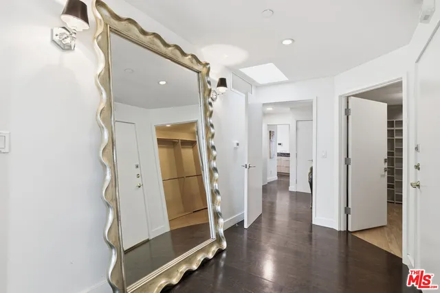 a view of a hallway with wooden floor and entryway
