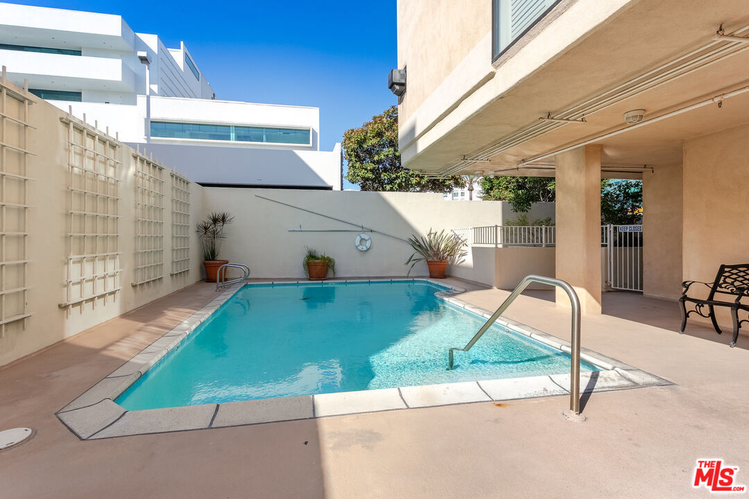 121 South Canon Drive, Unit PH 401 Beverly Hills, CA 90212 - Photo 25 of 31 a house view with a backyard space