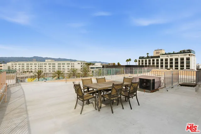 a view of a terrace with furniture and city view