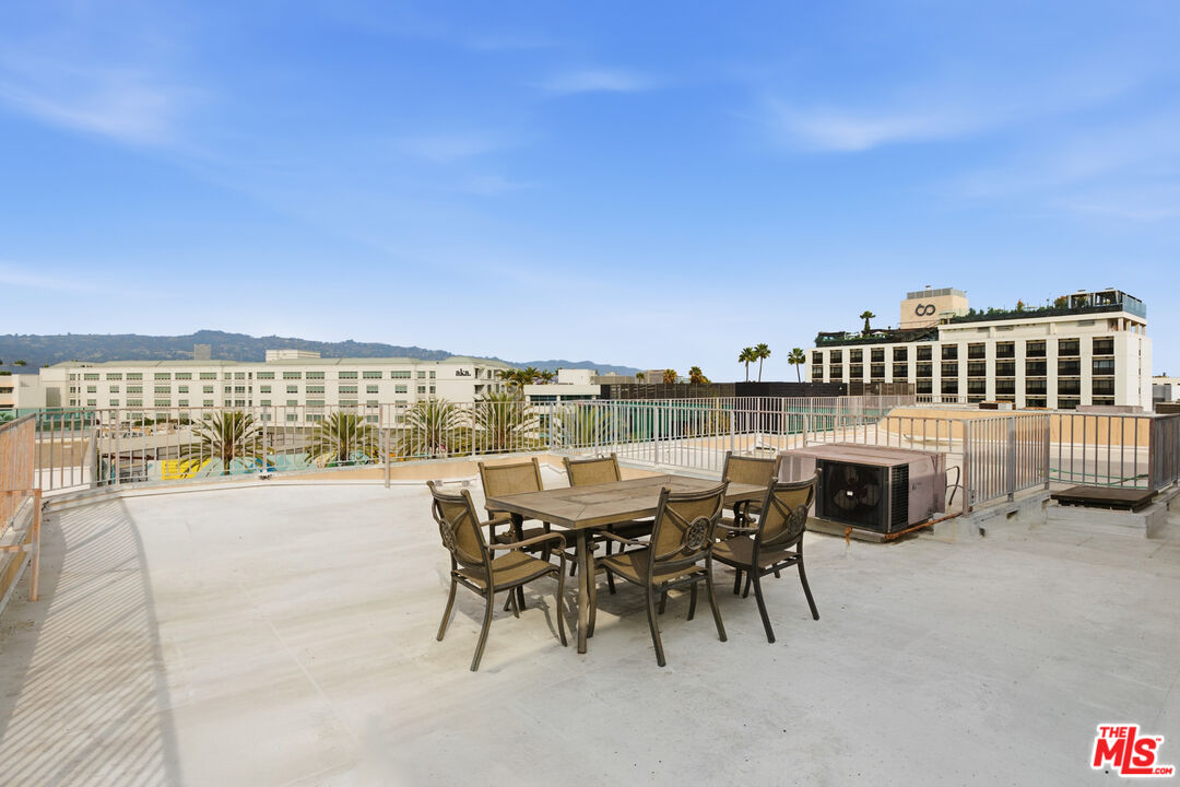121 South Canon Drive, Unit PH 401 Beverly Hills, CA 90212 - Photo 28 of 31 a view of a terrace with furniture and city view