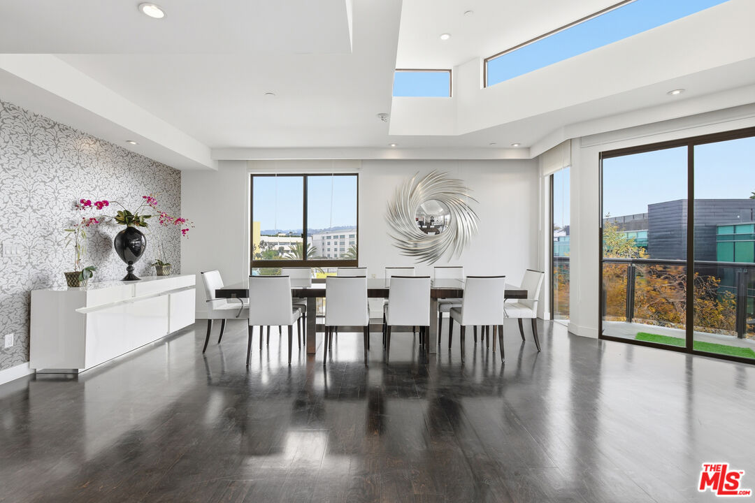 121 South Canon Drive, Unit PH 401 Beverly Hills, CA 90212 - Photo 3 of 31 a view of a dining room with furniture window and wooden floor