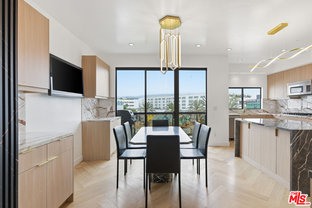 121 South Canon Drive, Unit PH 401 Beverly Hills, CA 90212 - Photo 8 of 31 a view of a dining room with furniture window and outside view