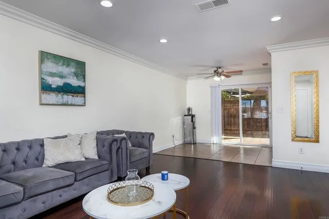 a living room with furniture and wooden floor