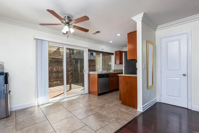 a open kitchen with stainless steel appliances granite countertop a refrigerator and a sink