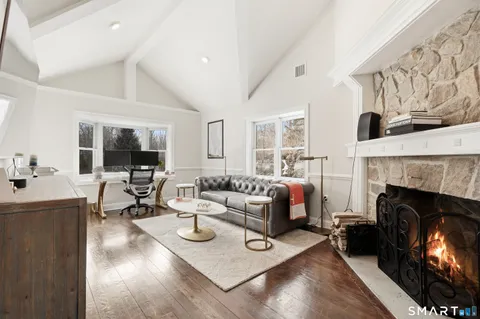 a living room with furniture fireplace and a table
