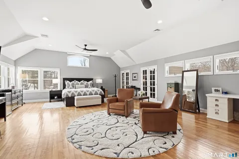 a bedroom with furniture and wooden floor