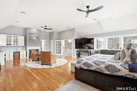 a bedroom with a bed and wooden floor