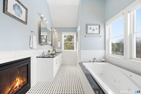 a large white kitchen with a large window