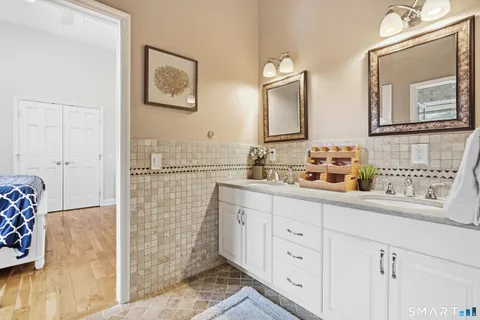 a bathroom with a double vanity sink mirror and