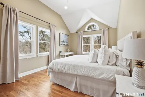 a bedroom with a large bed and a large window